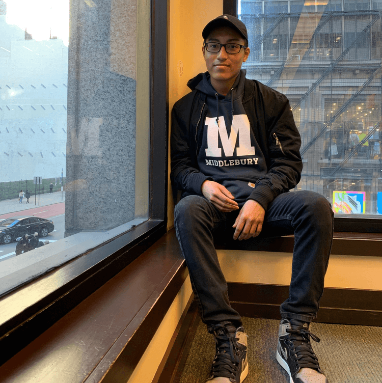 Brandon wears a Middlebury College sweatshirt for CollegeBound Month celebrations