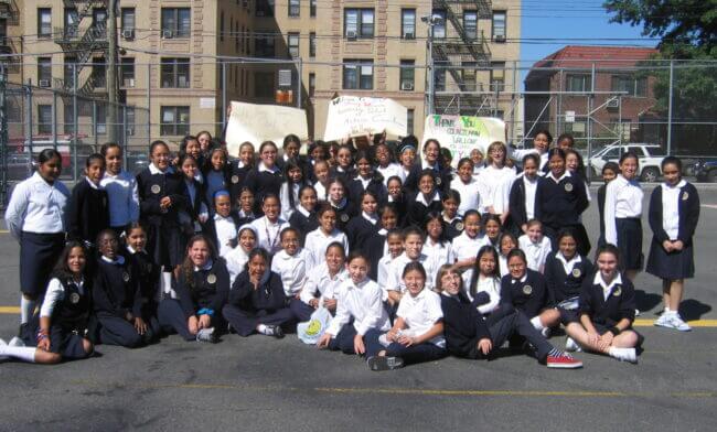 The first group of students at TYWLS Astoria take a group photo outside of the school.