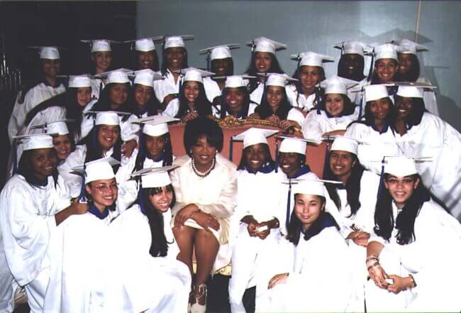 High school graduates take a group photo with the commencement speaker, Oprah Winfrey