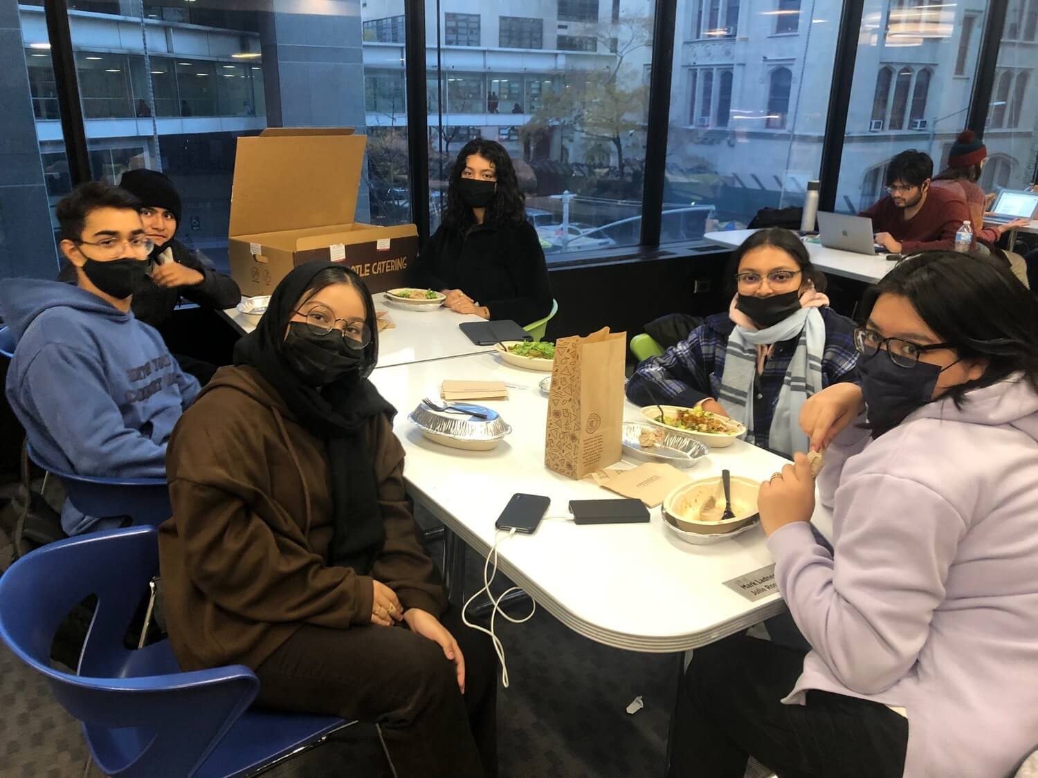 Bridge Through College students catch up over lunch and grow their community at Hunter College. 