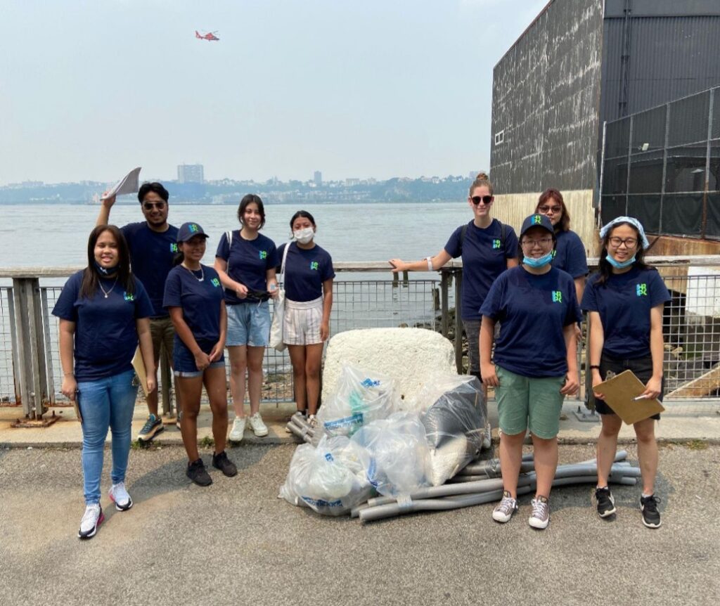 A group of TYWLS students pose for the camera with a bag of trash collected on and along the Hudson River. 