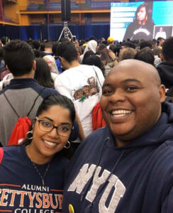 Stephanie and Rob are standing in a crowd at a decision day with Michelle Obama.