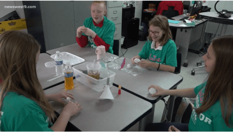 YWLA students working on an experiment around a table.