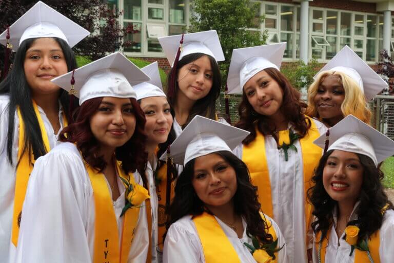 TYWLS Astoria graduates smile on their graduation day.