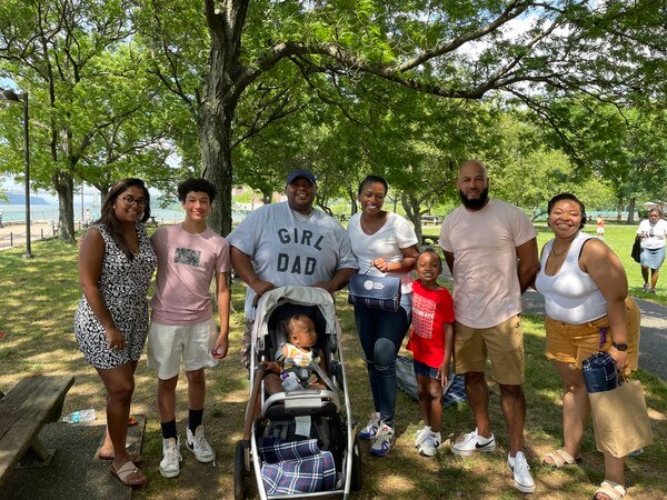 Members of the DEI Task Force along with their kids and other staff members take a picture at the Juneteenth picnic. 