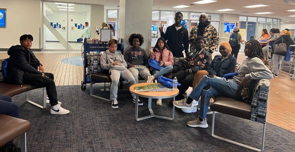A group of students take a break in the student common area at University at Buffalo. 