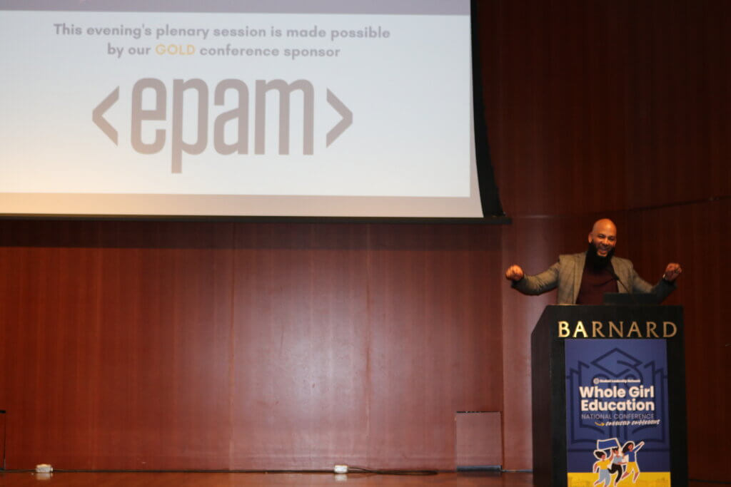 Jon Roure behind podium on stage with "This evening's plenary session is made possible by our Gold conference sponsor EPAM" on screen