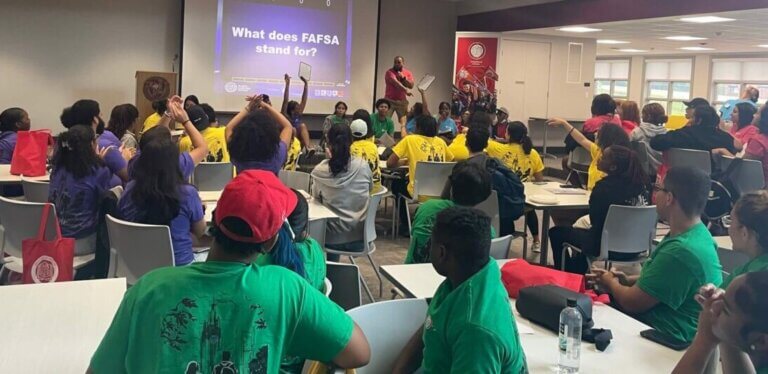 Group of students look at a screen with "Jeopardy" questions
