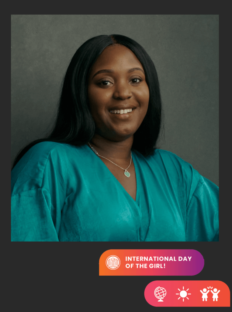 Alumna Talia Scott smiles to camera, with necklace and bright turquoise dress. Icons on lower right and text "International Day of the Girl"