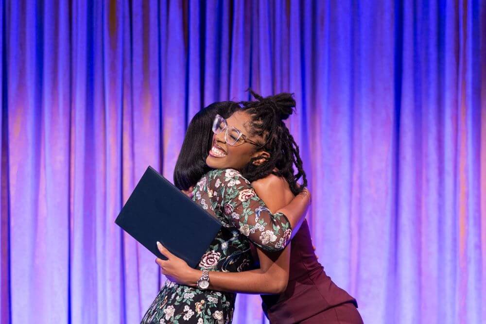 Alumna and (Em)Power Breakfast Honoree Cori Grainger hugs the award presenter