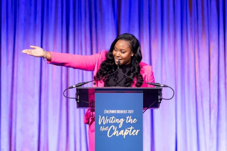 Alumna Talia Scott speaks at podium