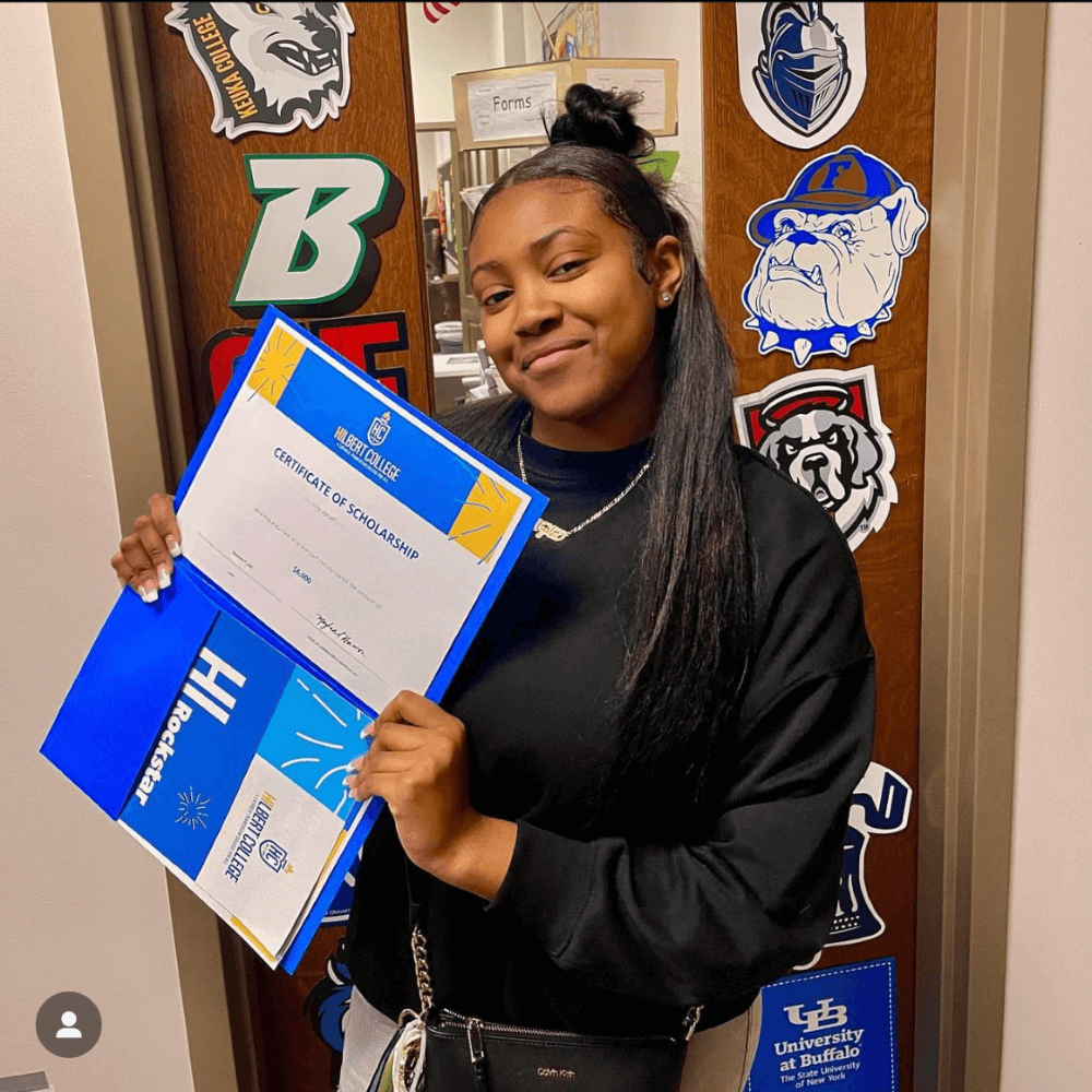 Student holding Hilbert College acceptance letter