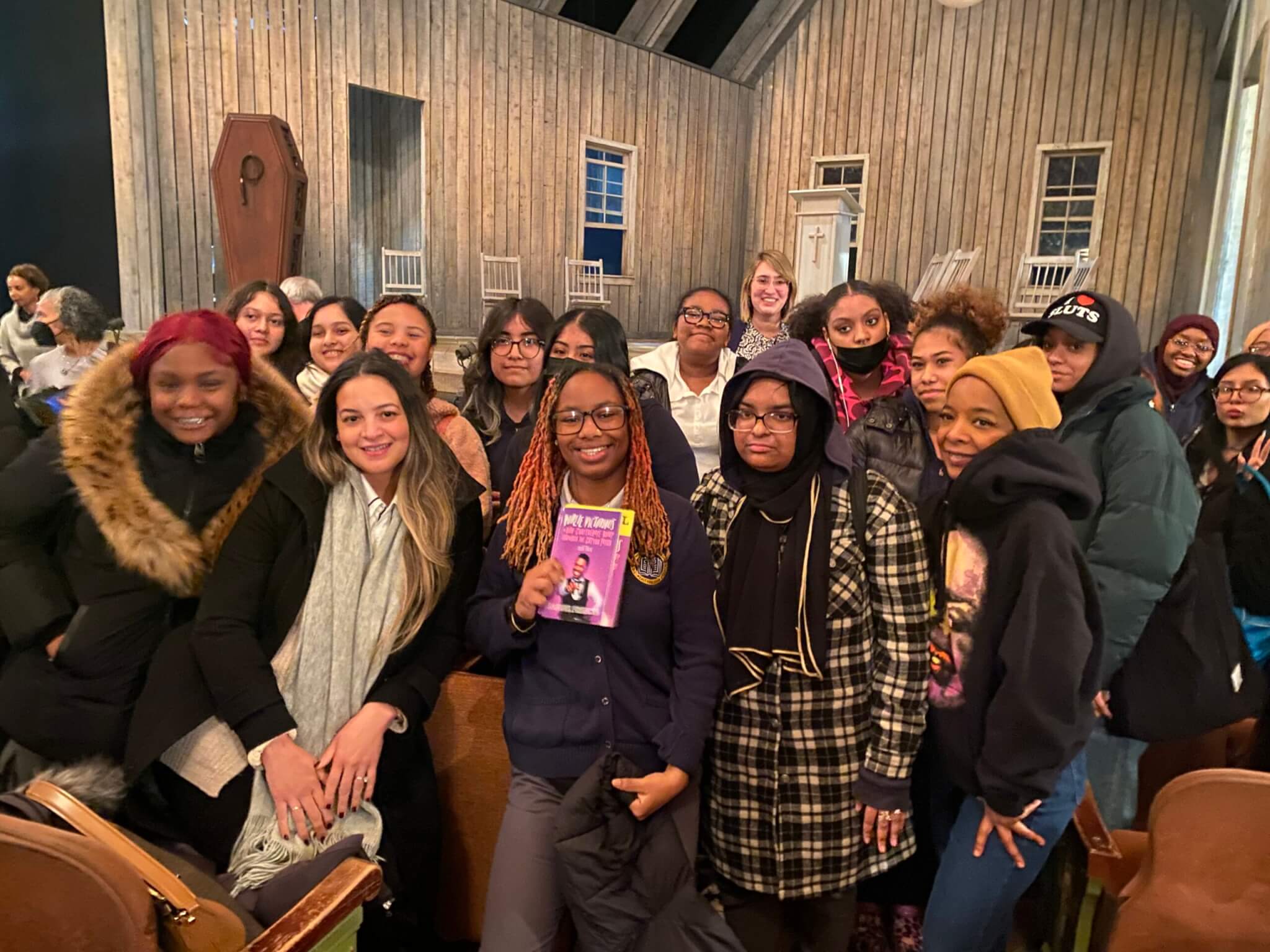 Students and Broadway actor Kara Young take photo in theater seats