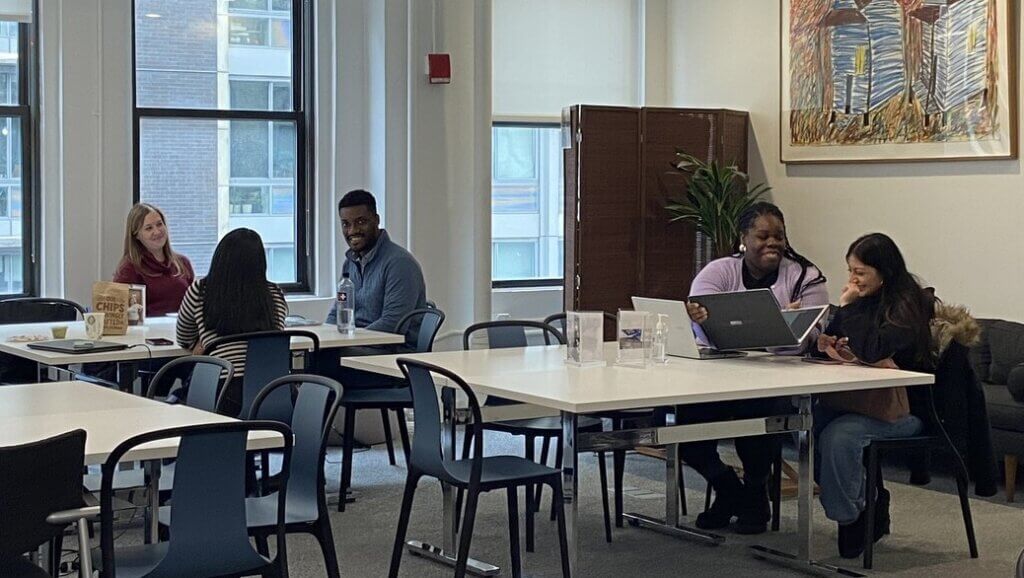 Financial aid counselors work one on with with students at tables