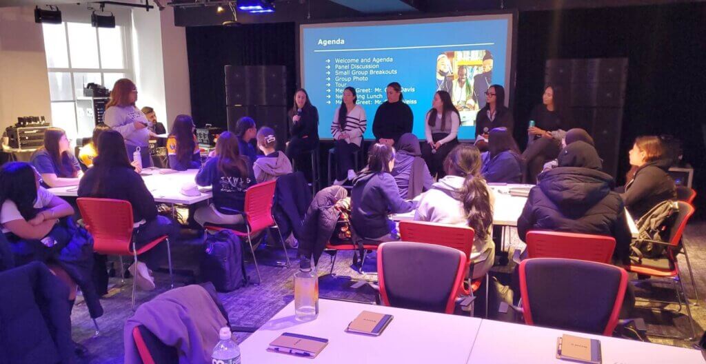 Panel of women employees from Sony sit at front of room for a panel about careers in music production and managemenet
