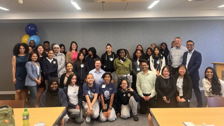 Group photo of adult volunteers from RBC and students who came to their office for career day