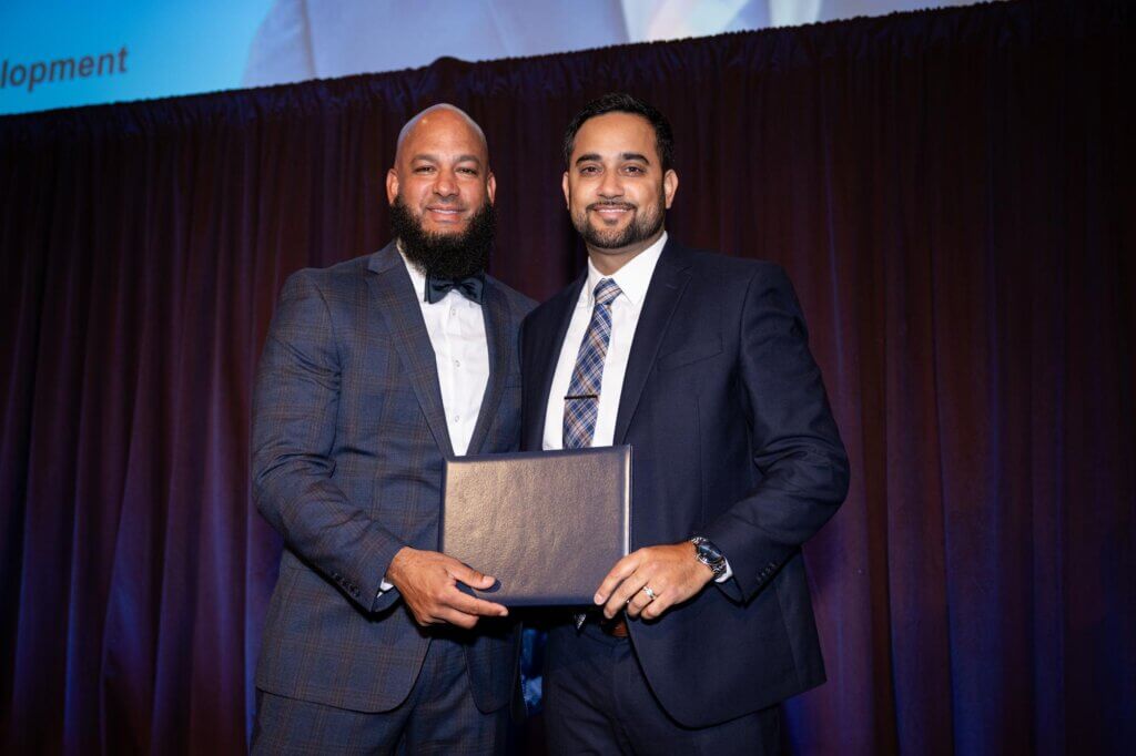 Jon Roure and Angel Santana hold certificate on stage
