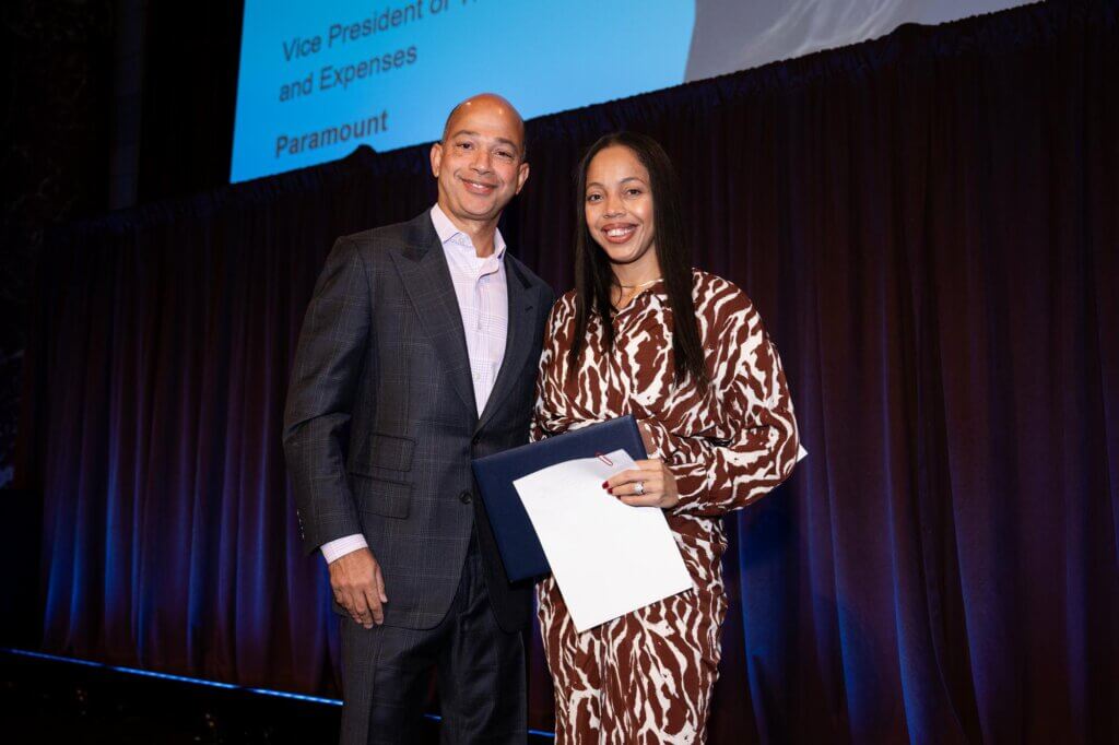 Scott Mills and Sharlim Raysor hold certificate on stage