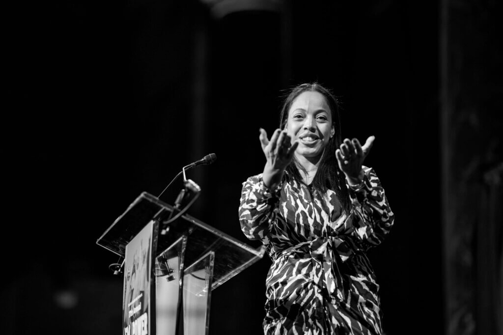 Event honoree Sharlim Raysor gestures to her family in the audience