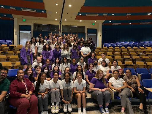 GALA students pose together in an auditorium.