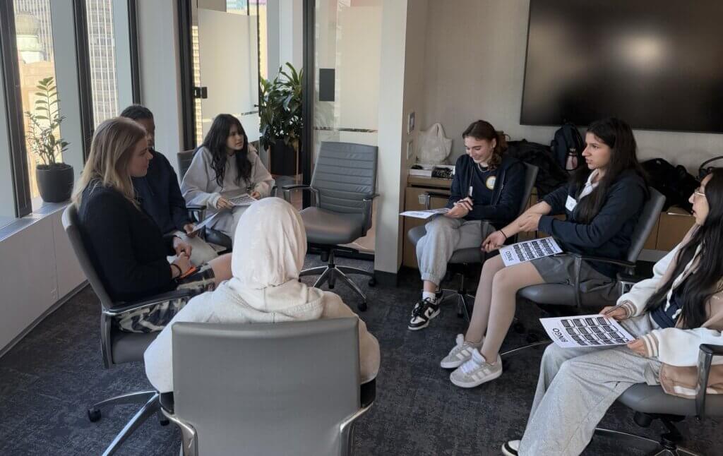 Group of students and BMO volunteer sit in a circle to for a Networking Bingo game
