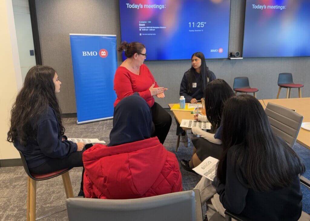 Group of students and BMO volunteer sit in a circle to for a Networking Bingo game