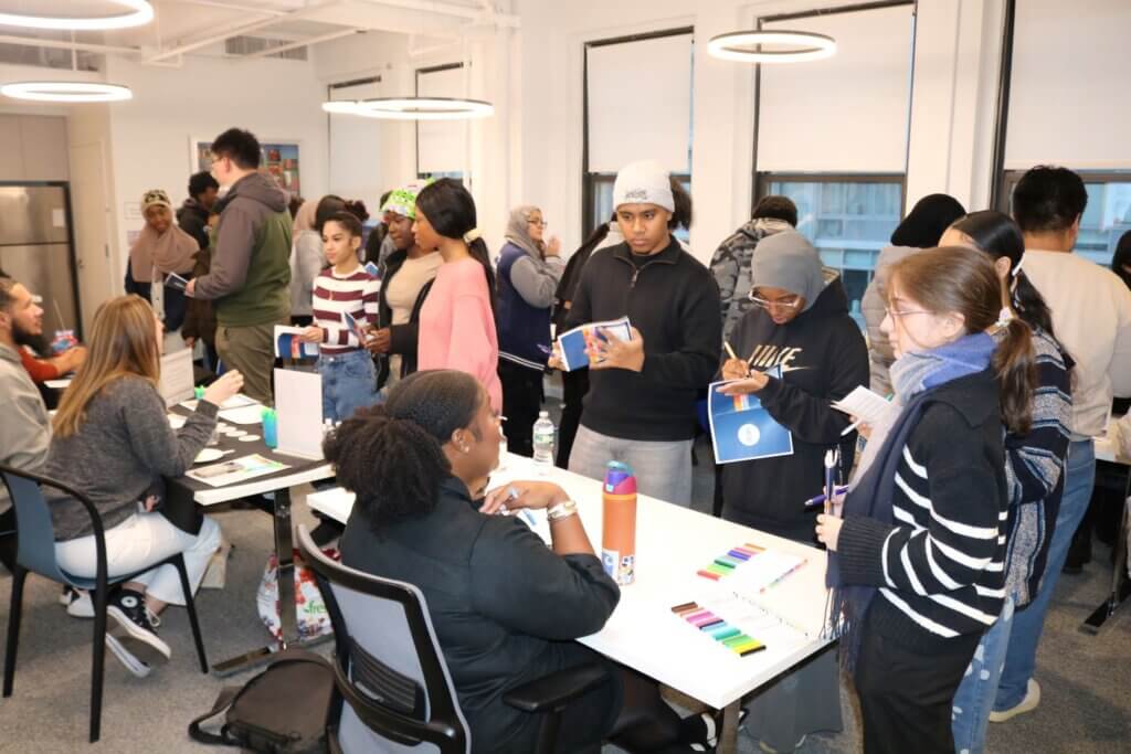 Students speak with program partners at a different tables