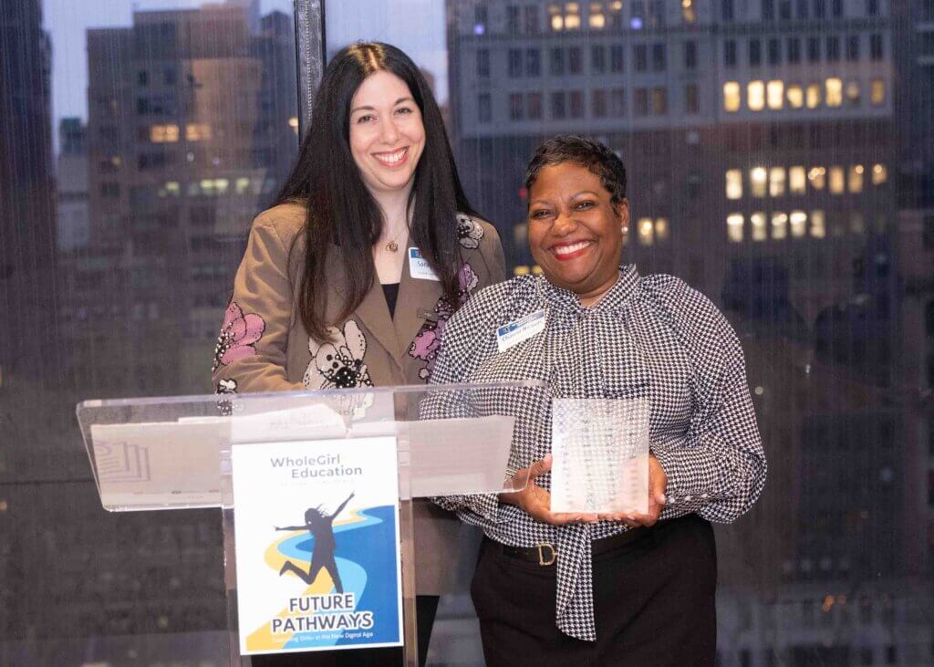 Sarah Boldin presents Charcia Nichols with an award plaque at the WholeGirl+ Education National Conference