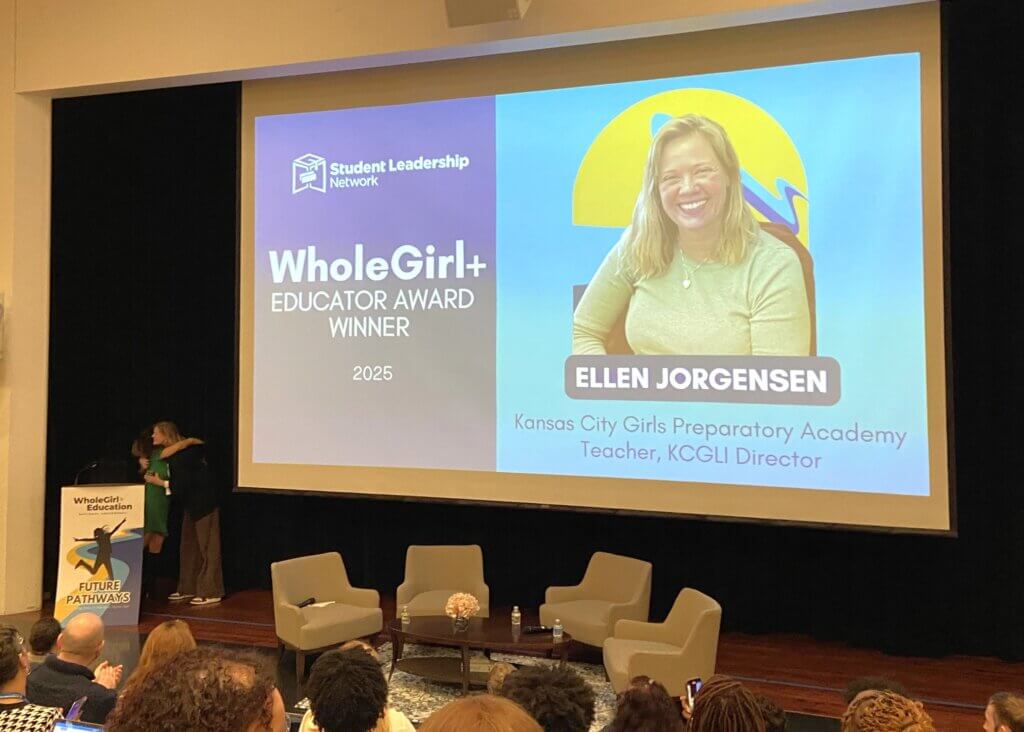 Ellen Jorgensen, a teacher, accepts the WholeGirl+ Educator Award on stage
