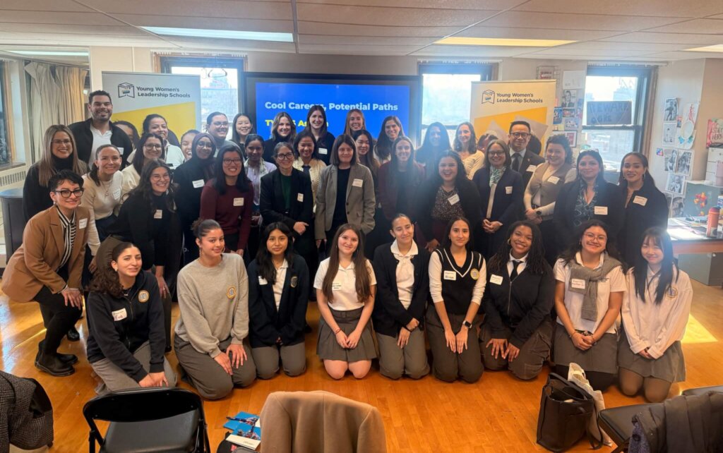 Students and volunteers pose for photo in TYWLS Astoria classroom