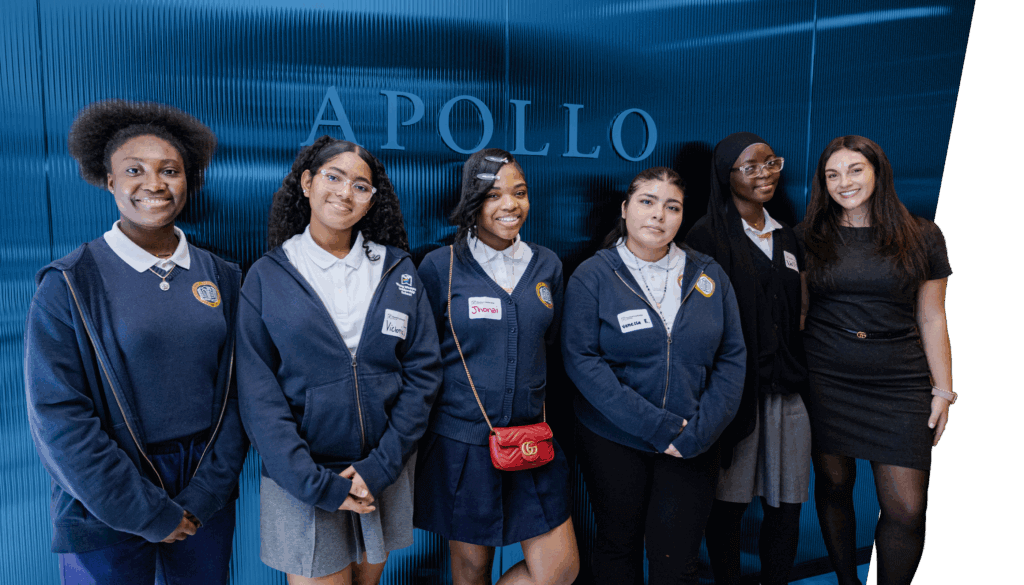 Six women stand in a line, dressed in formal or semi-formal attire, in front of a wall with the word APOLLO in large letters.