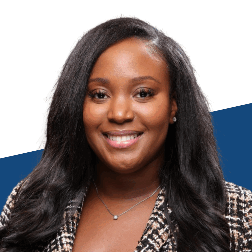Talia Scott, wearing a patterned blazer and necklace, smiles at the camera, as the first alumna member of Student Leadership Network's Board of Directors