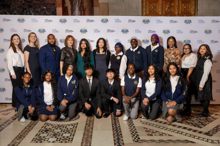 A group of students and adults pose together for a formal photo