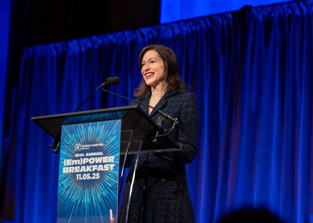 Stephanie Drescher speaks at the podium at the(Em)Power Breakfast event