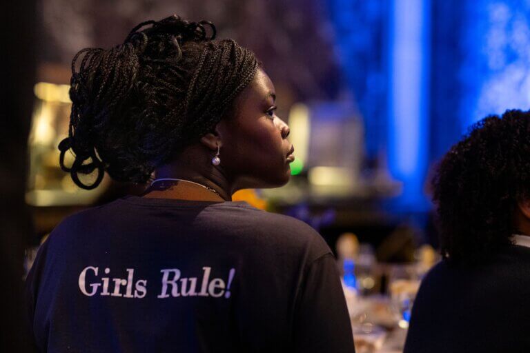 A student with braided hair wears a shirt that says Girls Rule!