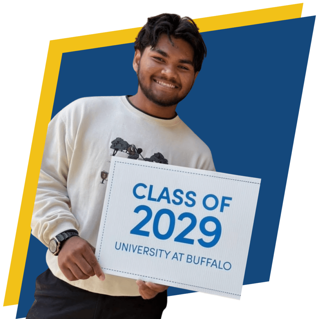 College Transition Coach Rob stands smiling, holding a sign that reads Class of 2029, University at Buffalo.