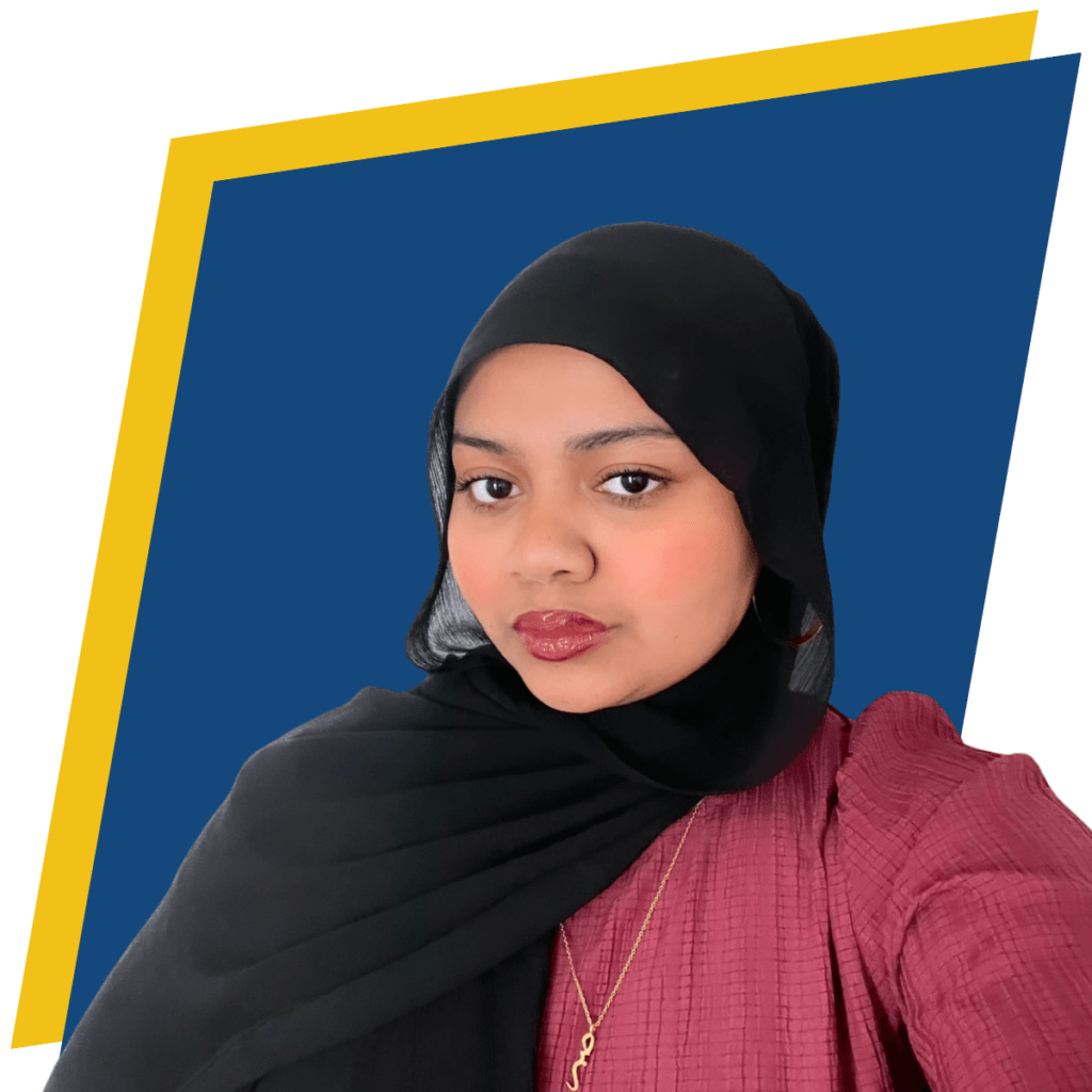 Woman wearing a black hijab and maroon top poses in front of a blue background with a yellow border.