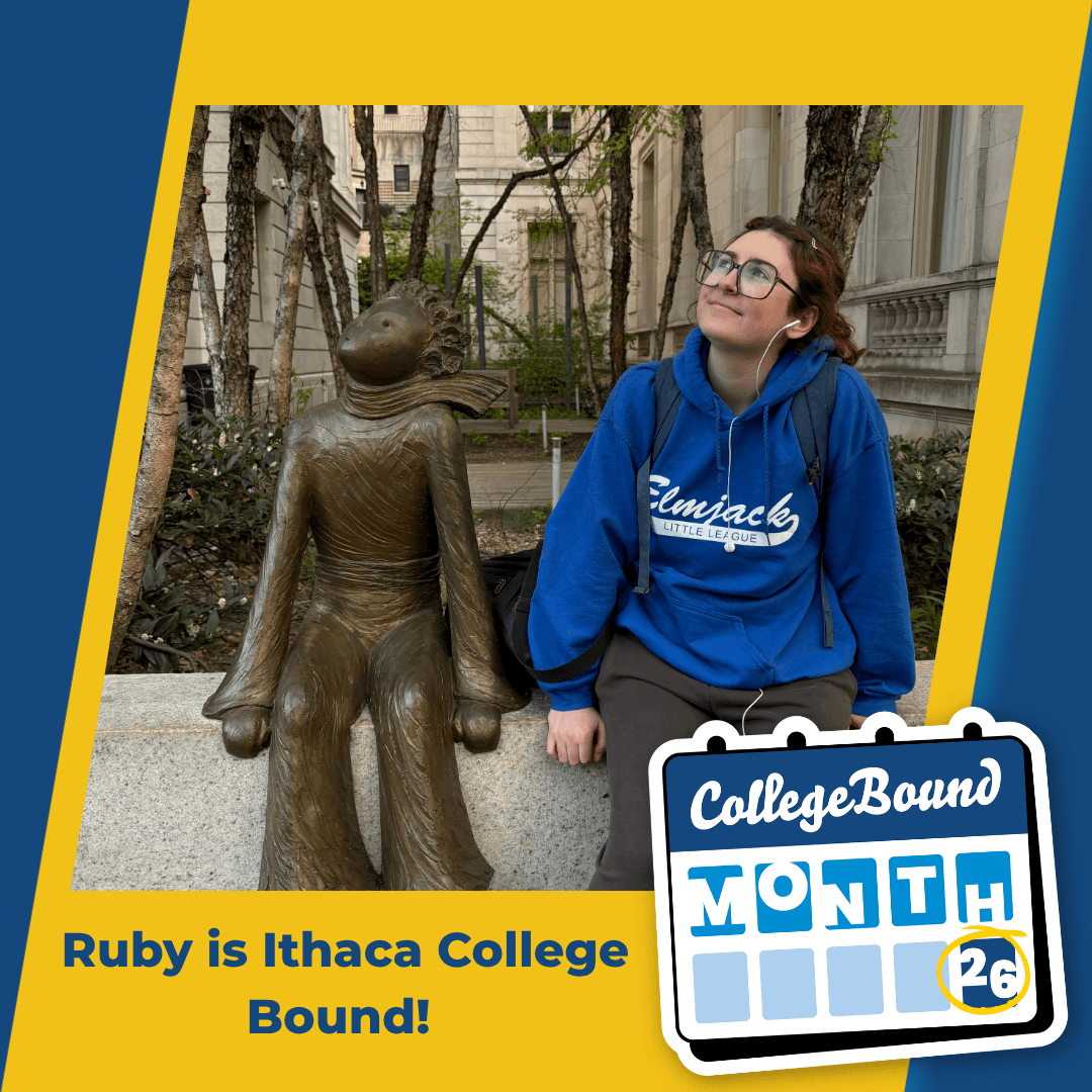 A young woman reads into a microphone in front of a colorful painting, with text stating, Ruby is Ithaca College Bound! and a calendar graphic marking the 26th.