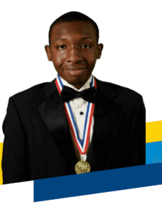 Young person in a black tuxedo and bow tie smiles at the camera, proudly wearing a gold medal with a red, white, and blue ribbon—an inspiring image featured in our Annual Report 2025.