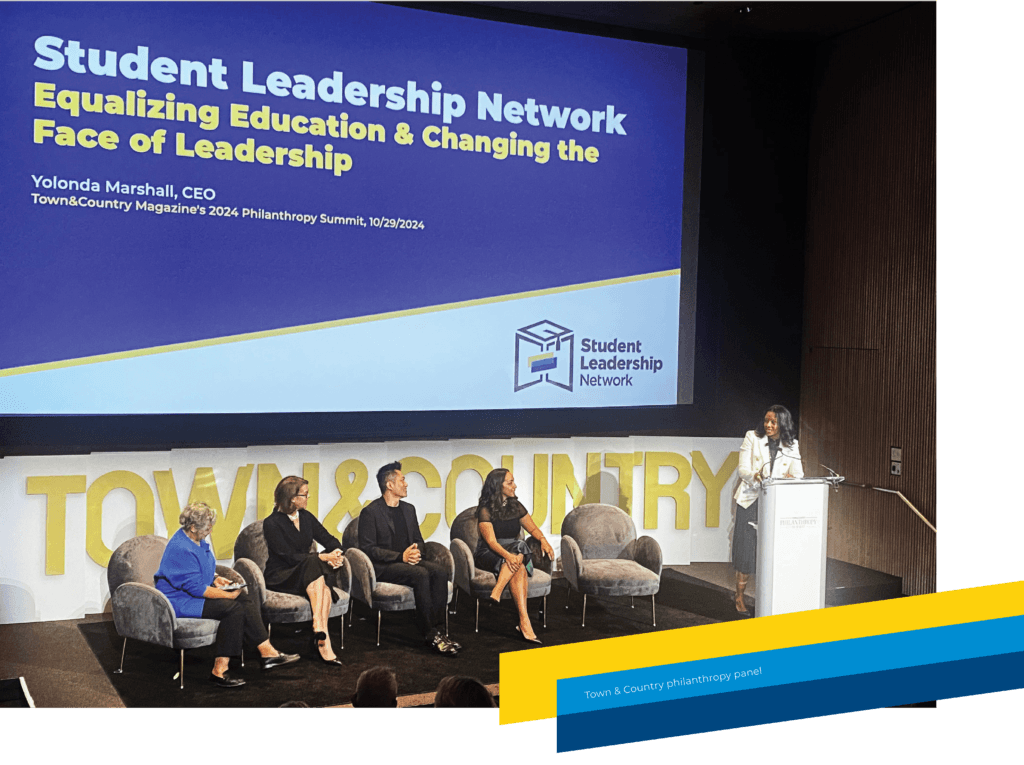 A panel of five people sits on stage beneath a large screen displaying Student Leadership Network: Equalizing Education & Changing the Face of Leadership at the 2025 Annual Report summit event.