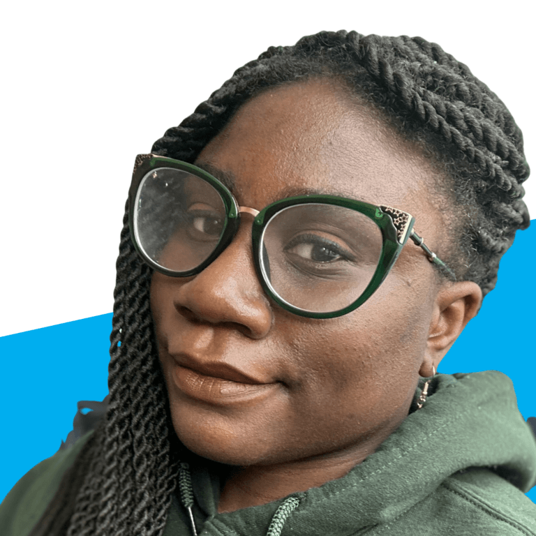 A person wearing green-framed glasses and a green hoodie, with long twisted hair, is looking at the camera against a white and blue background, exuding a style as vibrant and unique as Precious Byrd.
