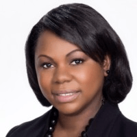 Woman with straight black hair, wearing a black blazer and necklace, facing forward and smiling slightly against a plain white background. Angela Nimoh, a professional in Securitization Finance at RBC Capital Markets, is poised and confident.